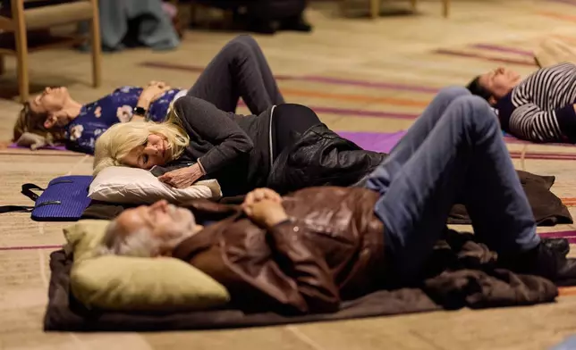 People partake in a sound bath at Temple Emanuel, Saturday, Dec. 6, 2025, in Beverly Hills, Calif. (AP Photo/Allison Dinner)