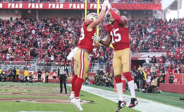 San Francisco 49ers wide receiver Jauan Jennings (15) celebrates his touchdown with running back Christian McCaffrey, left, during the second half of an NFL football game against the Tennessee Titans, Sunday, Dec. 14, 2025, in Santa Clara, Calif. (AP Photo/Jed Jacobsohn)