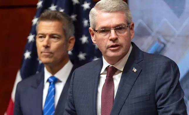 Derek Barrs, Administrator of the Federal Motor Carrier Safety Administration, speaks as Transportation Secretary Sean Duffy listens during a news conference at the Department of Transportation in Washington, Friday, Dec. 12, 2025. (AP Photo/Mark Schiefelbein)