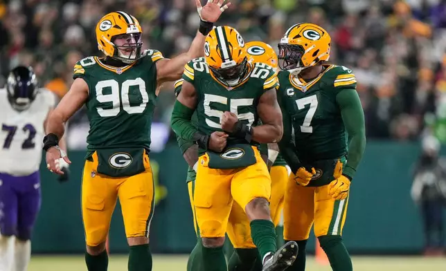 Green Bay Packers defensive end Kingsley Enagbare (55) celebrates after making a stop against Baltimore Ravens running back Derrick Henry during the second half of an NFL football game, Saturday, Dec. 27, 2025, in Green Bay, Wis. (AP Photo/Morry Gash)