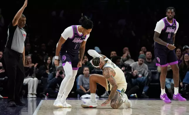 Minnesota Timberwolves guard Terrence Shannon Jr. (1) celebrates next to Milwaukee Bucks guard Gary Trent Jr. after making a three-point shot during the second half of an NBA basketball game, Sunday, Dec. 21, 2025, in Minneapolis. (AP Photo/Abbie Parr)