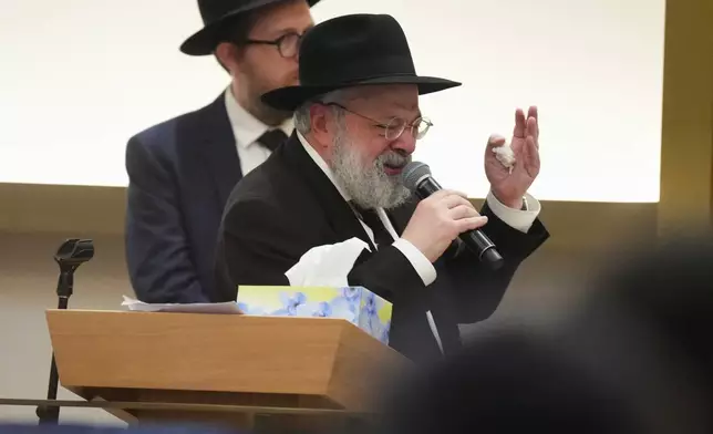 Rabbi Yehoram Ulman, father-in-law of Rabbi Eli Schlanger, a victim in the Bondi Beach mass shooting, speaks at his funeral at a synagogue in Bondi on Wednesday, Dec. 17, 2025, in Sydney, Australia. (AP Photo/Mark Baker, Pool)