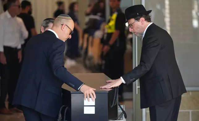 The coffin of Rabbi Yaakov Levitan, a victim in the Bondi Beach mass shooting, is carried into a chapel for his funeral in Sydney, Wednesday, Dec. 17, 2025. (AP Photo/Mark Baker)