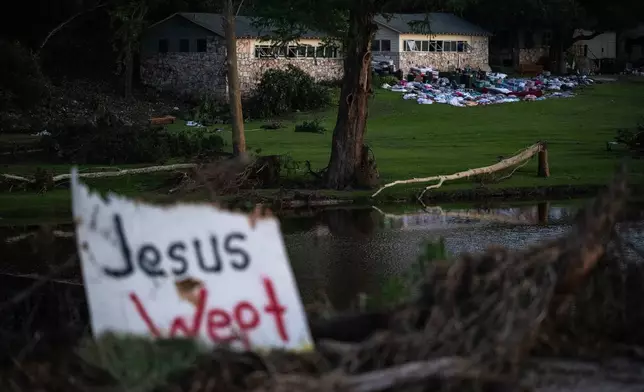 FILE - Camper's belongings sit outside one of Camp Mystic's cabins near the Guadalupe River after a flash flood swept through the area, July 7, 2025, in Hunt, Texas. (AP Photo/Eli Hartman, file)