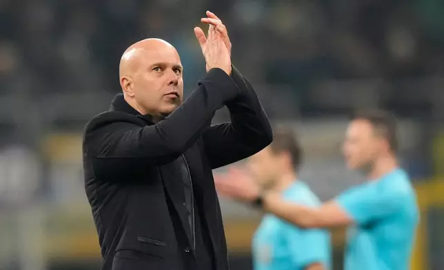 Liverpool's manager Arne Slot applauds at the end of a Champions League, league phase, soccer match between Inter Milan and Liverpool in Milan, Italy, Tuesday, Dec.9, 2025. (AP Photo/Luca Bruno)