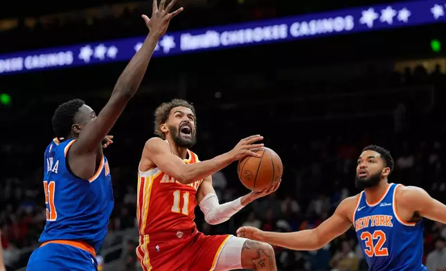 Atlanta Hawks guard Trae Young (11) shoots against New York Knicks forward Mohamed Diawara (51) during the first half of an NBA basketball game, Saturday, Dec. 27, 2025, in Atlanta. (AP Photo/Mike Stewart)