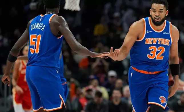 New York Knicks center Karl-Anthony Towns (32) celebrates his goal against the Atlanta Hawks during the first half of an NBA basketball game, Saturday, Dec. 27, 2025, in Atlanta. (AP Photo/Mike Stewart)