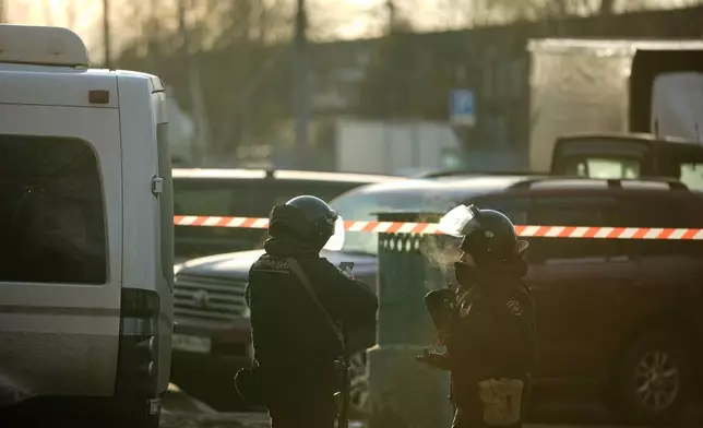 Police block the road near the scene of a deadly explosion in Moscow, Wednesday, Dec. 24, 2025. (AP Photo/Pavel Bednyakov)