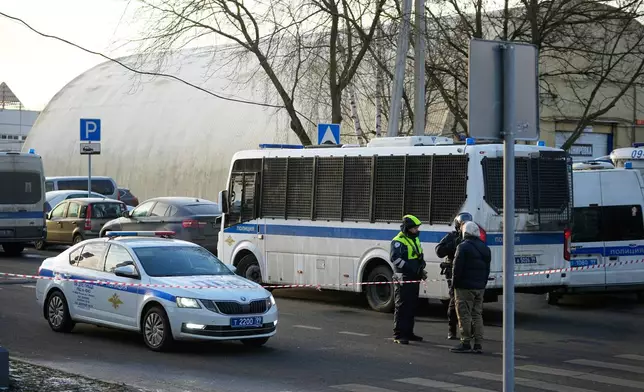 Police block the road near the scene of a deadly explosion in Moscow, Wednesday, Dec. 24, 2025. (AP Photo/Pavel Bednyakov)
