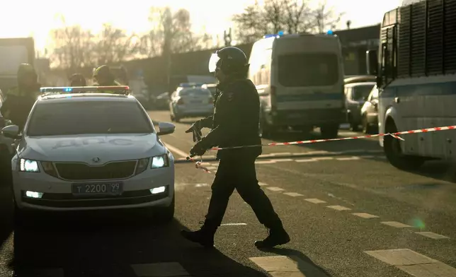 Police block the road near the scene of a deadly explosion in Moscow, Wednesday, Dec. 24, 2025. (AP Photo/Pavel Bednyakov)