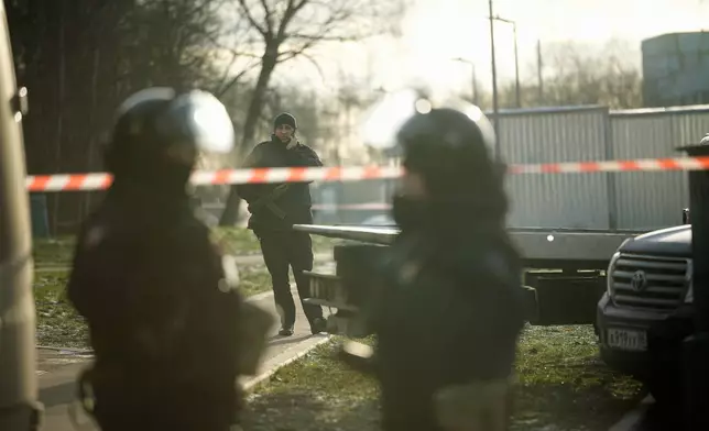 Police block the road near the scene of a deadly explosion in Moscow, Wednesday, Dec. 24, 2025. (AP Photo/Pavel Bednyakov)