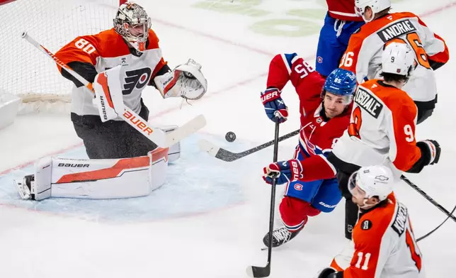 Montréal Canadiens' Alexandre Texier (85) scores on Philadelphia Flyers goaltender Dan Vladar (80) during the first period of an NHL hockey game, in Montreal, Tuesday, Dec. 16, 2025. (Christopher Katsarov/The Canadian Press via AP)