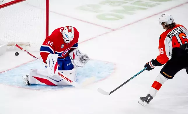 Philadelphia Flyers' Trevor Zegras (46) scores on Montreal Canadiens goaltender Jacob Fowler (32) during the second period of an NHL hockey game, in Montreal, Tuesday, Dec. 16, 2025. (Christopher Katsarov/The Canadian Press via AP)