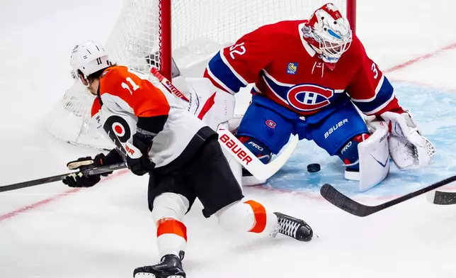 Montreal Canadiens goaltender Jacob Fowler (32) makes a save on Philadelphia Flyers' Travis Konecny (11) during second period NHL hockey action in Montreal on Tuesday, Dec. 16, 2025. (Christopher Katsarov/The Canadian Press via AP)