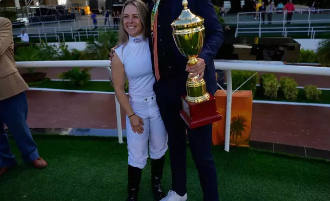 Jockey Katie Davis, of the United States, celebrates after winning a race during the 56th Jockey Challenge 56 at Rinconada racetrack in Caracas, Venezuela, Sunday, Dec 14, 2025. (AP Photo/Arian Cubillos)
