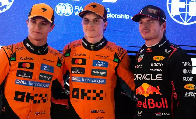 McLaren driver Oscar Piastri of Australia, pole position, center, is flanked by second best time McLaren driver Lando Norris of Britain, and Red Bull driver Max Verstappen of the Netherlands after the second qualifying session at the Lusail International Circuit ahead of the Qatar Formula One Grand Prix, in Lusail, Qatar, Saturday, Nov. 29, 2025. (AP Photo/Darko Bandic)