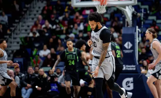 San Antonio Spurs forward Julian Champagnie reacts after a three-point basket against the New Orleans Pelicans during the first half of an NBA basketball game in New Orleans, Monday, Dec. 8, 2025. (AP Photo/Matthew Hinton)