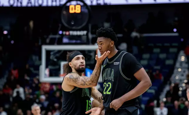 New Orleans Pelicans guard Jose Alvarado (15) tells center Derik Queen (22) to keep his chin up after he missed a last second shot that would have given the Pelicans the lead in the fourth quarter of an NBA basketball game against the San Antonio Spurs in New Orleans, Monday, Dec. 8, 2025. (AP Photo/Matthew Hinton)