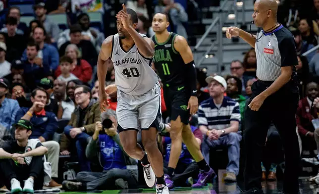San Antonio Spurs forward Harrison Barnes (40) reacts after a three-point basket against New Orleans Pelicans guard Bryce McGowens (11) during the first half of an NBA basketball game in New Orleans, Monday, Dec. 8, 2025. (AP Photo/Matthew Hinton)