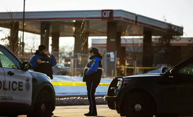 Omaha police investigate an incident at a QuikTrip gas station, that injured three officers and left the suspect dead in Omaha, Neb., Wednesday, Dec. 3, 2025. (Chris Machian/Omaha World-Herald via AP)