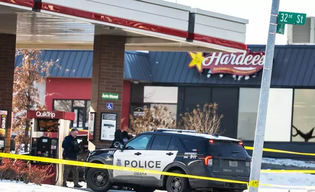 Omaha police investigate an incident at a QuikTrip gas station, that injured three officers and left the suspect dead in Omaha, Neb., Wednesday, Dec. 3, 2025. (Chris Machian/Omaha World-Herald via AP)