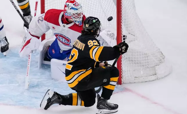 Boston Bruins center Marat Khusnutdinov (92) scores on Montreal Canadiens goaltender Jacob Fowler (32) during the first period of an NHL hockey game, Tuesday, Dec. 23, 2025, in Boston. (AP Photo/Charles Krupa)
