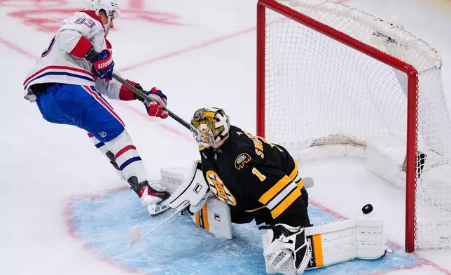 Montreal Canadiens right wing Ivan Demidov (93) scores on Boston Bruins goaltender Jeremy Swayman (1) during the second period of an NHL hockey game, Tuesday, Dec. 23, 2025, in Boston. (AP Photo/Charles Krupa)