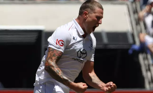 England's Brydon Carse celebrates the wicket of Australia's Mitchell Starc on Day 2 of their Ashes cricket test match in Melbourne, Saturday, Dec. 27, 2025. (AP Photo/Hamish Blair)