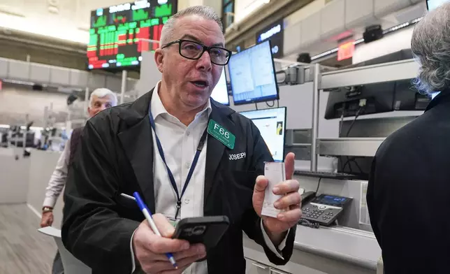 Options trader Joseph D'Arrigo works on the floor of the New York Stock Exchange, Tuesday, Dec. 2, 2025. (AP Photo/Richard Drew)