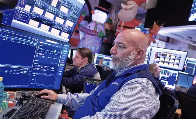 Trader Vincent Napolitano works on the floor of the New York Stock Exchange, Tuesday, Dec. 2, 2025. (AP Photo/Richard Drew)