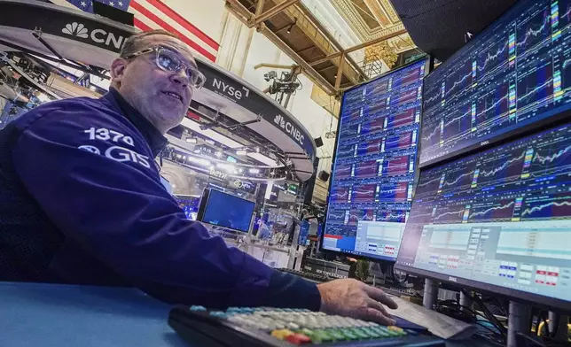 Specialist Anthony Matesic works on the floor of the New York Stock Exchange, Thursday, Nov. 20, 2025. (AP Photo/Richard Drew)