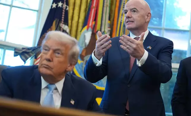 FILE - President Donald Trump listens as FIFA President Gianni Infantino speaks during a meeting with the White House task force on the 2026 FIFA World Cup in the Oval Office of the White House, Nov. 17, 2025, in Washington. (AP Photo/Evan Vucci, File)