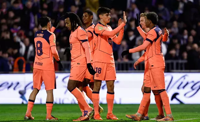 Barcelona's Marcus Rashford, third left, celebrates after scoring his side's second goal with his teammates during the Copa del Rey soccer match between Guadalajara and Barcelona in Guadalajara, Spain, Tuesday, Dec. 16, 2025. (AP Photo/Rudy Garcia)