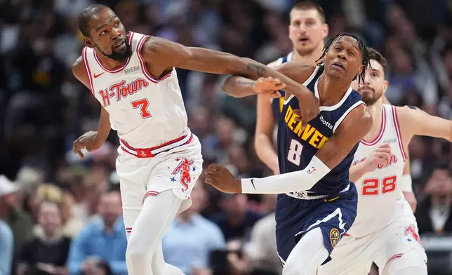 Houston Rockets forward Kevin Durant (7) and Denver Nuggets guard Peyton Watson (8) pursue the ball in the first half of an NBA basketball game Monday, Dec. 15, 2025, in Denver. (AP Photo/David Zalubowski)