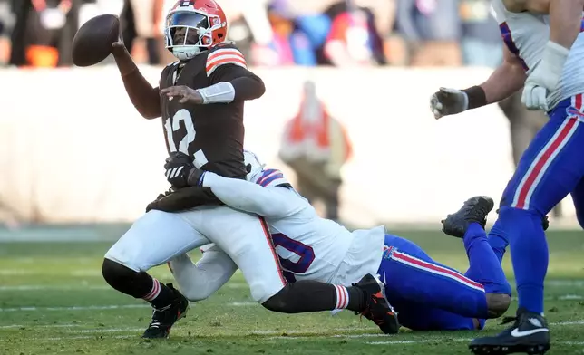 Cleveland Browns quarterback Shedeur Sanders (12) is sacked by Buffalo Bills defensive end Greg Rousseau during the second half of an NFL football game in Cleveland, Sunday, Dec. 21, 2025. (AP Photo/Sue Ogrocki)