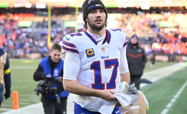 Buffalo Bills quarterback Josh Allen (17) leave the field after an NFL football game against the Cleveland Browns in Cleveland, Sunday, Dec. 21, 2025. (AP Photo/David Richard)