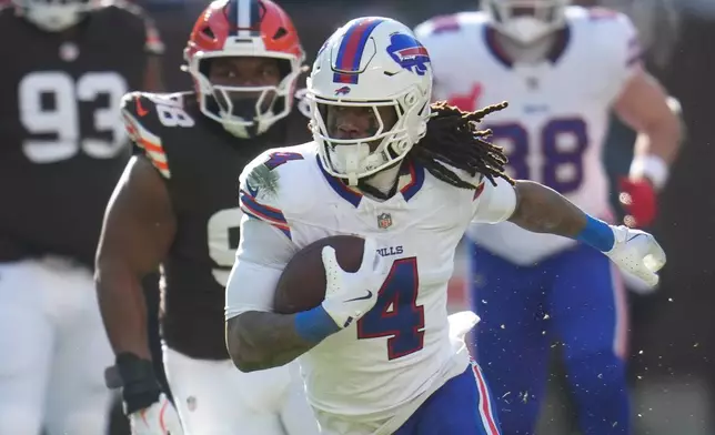 Buffalo Bills running back James Cook III (4) runs the ball for a touchdown against the Cleveland Browns during the first half of an NFL football game in Cleveland, Sunday, Dec. 21, 2025. (AP Photo/Sue Ogrocki)