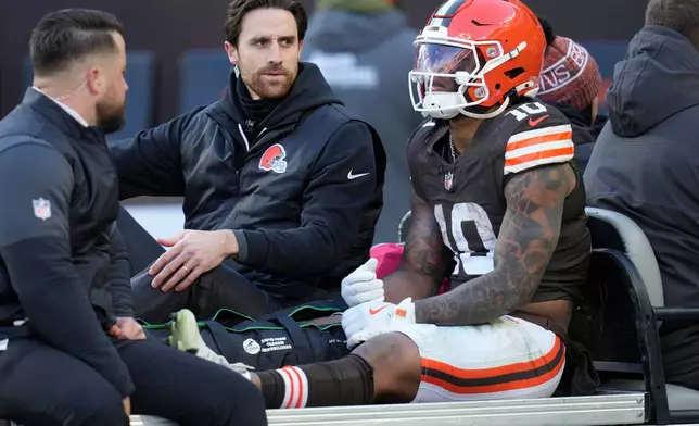 Cleveland Browns running back Quinshon Judkins (10) is carted off the field with an injury against the Buffalo Bills during the first half of an NFL football game in Cleveland, Sunday, Dec. 21, 2025. (AP Photo/Sue Ogrocki)