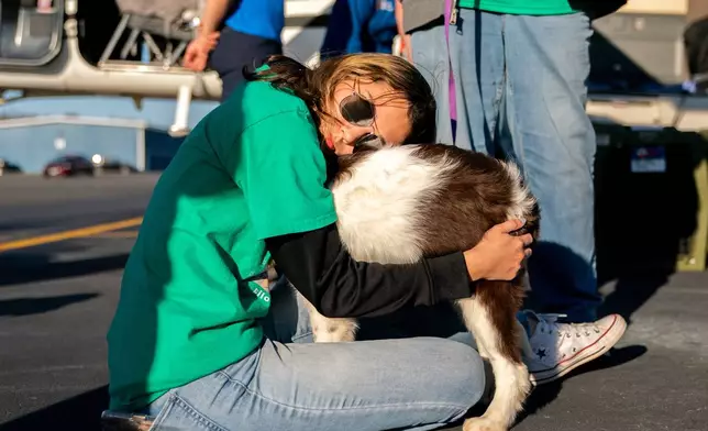 Katelynn Aldarondo says goodbye to the nameless dog she grew close to, Nov. 23, 2025, at Culpeper Regional Airport in Brandy Station, Va. (AP Photo/Allison Robbert)