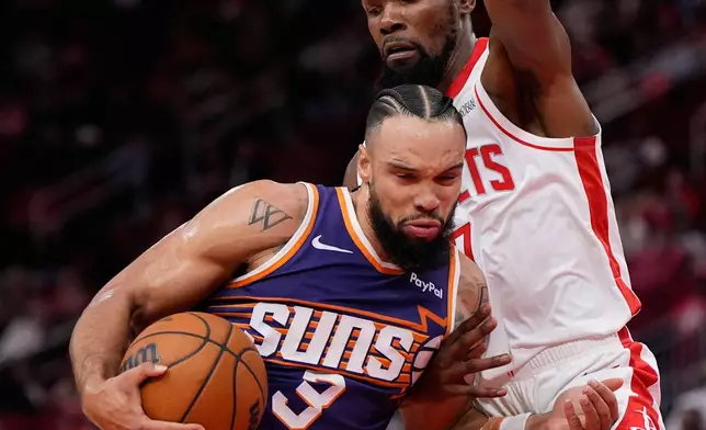 Phoenix Suns forward Dillon Brooks (3) controls the ball against Houston Rockets forward Kevin Durant (7) during the first half of an NBA basketball game in Houston, Friday, Dec. 5, 2025. (AP Photo/Ashley Landis)