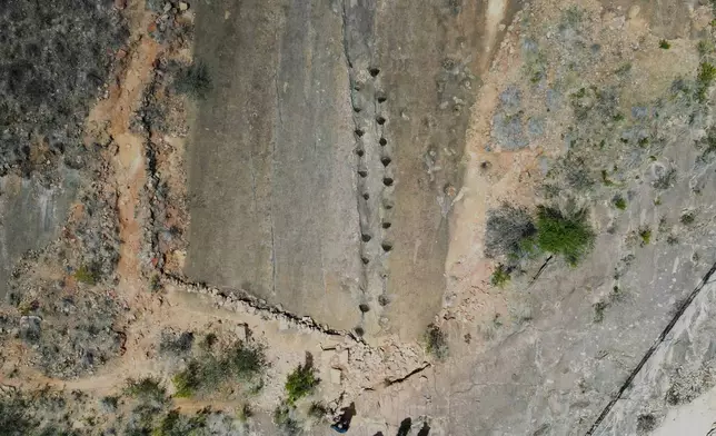 Petrified footprints by dinosaurs are visible in Carreras Pampa in Toro Toro National Park, north of Potosi, Bolivia, Saturday, Dec. 6, 2025. (AP Photo/Juan Karita)