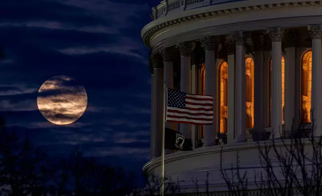The last super moon of the year, the "Cold Supermoon," rises behind the U.S. Capitol, Thursday, Dec. 4, 2025, in Washington. (AP Photo/Alex Brandon)