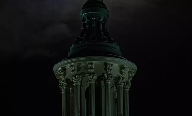 The last super moon of the year, the "Cold Supermoon," rises behind the Statue of Freedom atop the U.S. Capitol, Thursday, Dec. 4, 2025, in Washington. (AP Photo/Alex Brandon)
