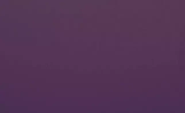 The full supermoon rises beyond a spirit statue atop the Liberty Memorial tower at the National World War Museum, Thursday, Dec. 4, 2025, in Kansas City, Mo. (AP Photo/Charlie Riedel)