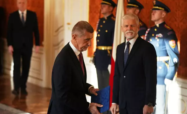 Leader of ANO political movement Andrej Babis, left, is sworn in as the country's new prime minister by Czech Republic's President Petr Pavel at the Prague Castle in Prague, Czech Republic, Tuesday, Dec. 9, 2025. (AP Photo/Petr David Josek)