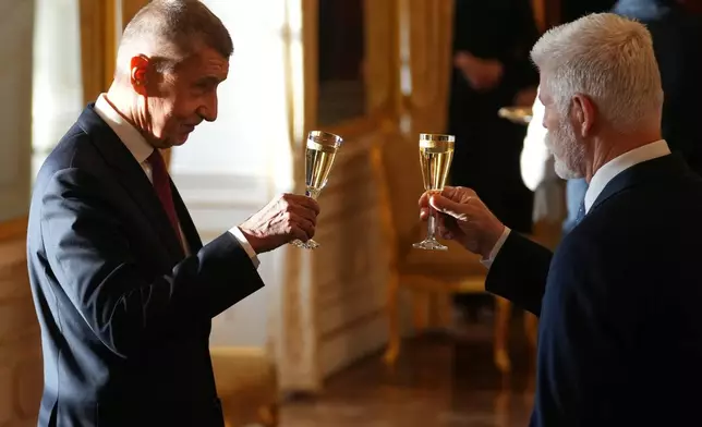 Leader of ANO political movement Andrej Babis, left, toasts with Czech Republic's President Petr Pavel after being sworn in as the country's new prime minister at the Prague Castle in Prague, Czech Republic, Tuesday, Dec. 9, 2025. (AP Photo/Petr David Josek)