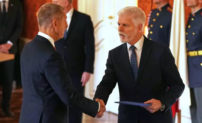Leader of ANO political movement Andrej Babis, left, is sworn in as the country's new prime minister by Czech Republic's President Petr Pavel at the Prague Castle in Prague, Czech Republic, Tuesday, Dec. 9, 2025. (AP Photo/Petr David Josek)