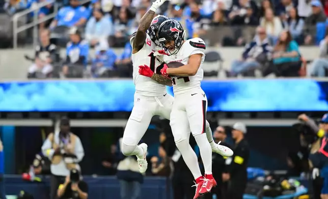 Houston Texans wide receiver Jaylin Noel, right, celebrates his touchdown with wide receiver Nico Collins during the first half of an NFL football game Saturday, Dec. 27, 2025, in Inglewood, Calif. (AP Photo/Wally Skalij)