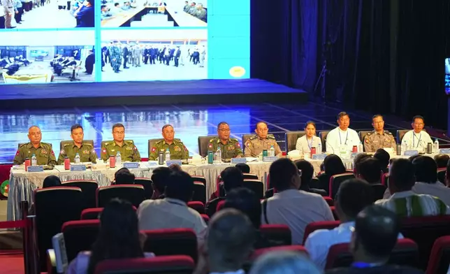 Major Gen. Zaw Min Tun, fifth from left, leader of the military information team, speaks during a news conference on national level efforts to completely eliminate online scams and dismantle their networks at the root, Sunday, Dec. 14, 2025, in Yangon, Myanmar. (AP Photo/Thein Zaw)