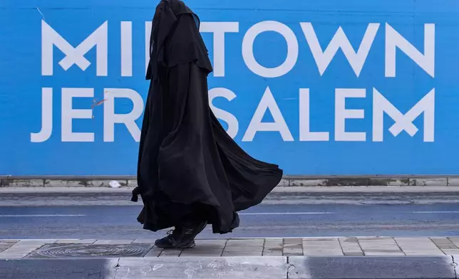 A Jewish woman from the Haredi burqa sect makes her way through central Jerusalem, on Tuesday, Dec 30, 2025. (AP Photo/Ohad Zwigenberg)